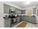 Updated kitchen with stainless steel appliances, contemporary cabinets, and modern countertops at 927 Ferncrest Dr, Durham, NC 27705