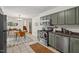 Kitchen with stainless steel appliances and a dining area with modern light fixture at 927 Ferncrest Dr, Durham, NC 27705