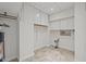 Neat laundry room featuring tiled floor, white cabinets, and a utility sink at 927 Ferncrest Dr, Durham, NC 27705