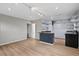 Spacious living room featuring modern track lighting, vinyl flooring, and a kitchen area at 927 Ferncrest Dr, Durham, NC 27705