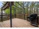 Wooden deck with a grill, metal pergola, and views of the surrounding wooded backyard at 102 Swallow Hill Ct, Cary, NC 27513