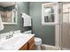 Bathroom features a wooden vanity, toilet, and walk-in shower with glass door at 102 Swallow Hill Ct, Cary, NC 27513