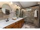 Bathroom with double sink vanity, decorative tile, and walk-in shower with glass door at 102 Swallow Hill Ct, Cary, NC 27513