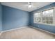 Comfortable bedroom with neutral carpet, natural light, and a ceiling fan at 102 Swallow Hill Ct, Cary, NC 27513