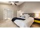 Bright bedroom with a ceiling fan, neutral carpet, and French doors to the en suite at 102 Swallow Hill Ct, Cary, NC 27513