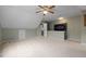 Light-filled bonus room with neutral carpet, an adjoining bathroom and a ceiling fan at 102 Swallow Hill Ct, Cary, NC 27513