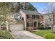 Charming two-story home with a brick facade, a well-manicured lawn, and blossoming trees at 102 Swallow Hill Ct, Cary, NC 27513