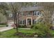 Lovely home with blooming bushes, dark shutters, and a well-maintained front lawn at 102 Swallow Hill Ct, Cary, NC 27513