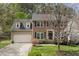 Beautiful two-story home featuring brick accents, a driveway, and a lush green lawn at 102 Swallow Hill Ct, Cary, NC 27513