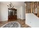 Open foyer with a staircase, a stylish rug, wood-look floors, and a china cabinet at 102 Swallow Hill Ct, Cary, NC 27513