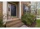Close-up of an elegant front door with brick steps and decorative sidelights at 102 Swallow Hill Ct, Cary, NC 27513
