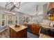 Spacious kitchen with wooden island, sink, and stainless-steel appliances at 102 Swallow Hill Ct, Cary, NC 27513
