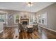Inviting living room features a fireplace and large windows for ample natural light at 102 Swallow Hill Ct, Cary, NC 27513