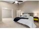 Large bedroom with neutral carpeting, ceiling fan, and tasteful furniture at 102 Swallow Hill Ct, Cary, NC 27513