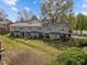 Backyard featuring a well-maintained lawn and gray siding of the units at 103 Friar Ln, Carrboro, NC 27510