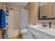 Bright bathroom features a vanity with sink, mirror, shower, and decorative shower curtain at 103 Friar Ln, Carrboro, NC 27510