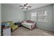 This bedroom features carpet, a ceiling fan, two windows, and unique furniture at 103 Friar Ln, Carrboro, NC 27510
