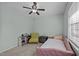 This bedroom features carpet, a ceiling fan, two windows, and unique furniture at 103 Friar Ln, Carrboro, NC 27510