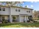 Exterior view of the back of the home with a sliding glass door to an outdoor patio at 103 Friar Ln, Carrboro, NC 27510