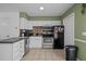 Bright kitchen features white cabinets and modern appliances at 103 Friar Ln, Carrboro, NC 27510