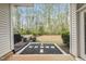 Covered back porch offering serene views of lush greenery, creating a peaceful retreat for outdoor relaxation at 111 Wards Ridge Dr, Cary, NC 27513