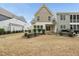 Backyard featuring well-maintained lawn, mature shrubbery, and a covered patio enhancing outdoor appeal at 111 Wards Ridge Dr, Cary, NC 27513