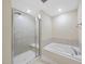 A bathroom featuring a glass-door shower and a soaking tub at 111 Wards Ridge Dr, Cary, NC 27513