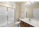 A bright bathroom featuring a glass shower door, vanity, and neutral color scheme at 111 Wards Ridge Dr, Cary, NC 27513