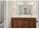 Bathroom featuring a double sink vanity, ample lighting, and a large mirror enhancing the room's appeal at 111 Wards Ridge Dr, Cary, NC 27513