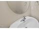 Close-up of a bathroom sink with a modern faucet and a round mirror at 111 Wards Ridge Dr, Cary, NC 27513