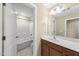 Bathroom featuring double sink vanity and shower-tub combination, enhanced by a light and airy ambiance at 111 Wards Ridge Dr, Cary, NC 27513