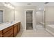 Bathroom featuring a walk-in closet, stand alone shower, and vanity at 111 Wards Ridge Dr, Cary, NC 27513