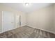 This bedroom features neutral walls and carpet, with a view into an ensuite bathroom at 111 Wards Ridge Dr, Cary, NC 27513