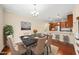 Bright dining area with hardwood floors, chandelier, and adjacent kitchen with barstool seating at 111 Wards Ridge Dr, Cary, NC 27513