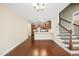 Open concept living space with wood floors, stairs, and view of the kitchen at 111 Wards Ridge Dr, Cary, NC 27513