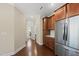 A kitchen featuring wood cabinets, stainless appliances, and hardwood floors, with a view of laundry at 111 Wards Ridge Dr, Cary, NC 27513