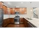 A kitchen with stainless steel appliances, granite counters, wood cabinets, gas cooktop, and undermount sink at 111 Wards Ridge Dr, Cary, NC 27513
