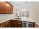 A kitchen featuring a stainless steel sink, granite countertop, and wood cabinets at 111 Wards Ridge Dr, Cary, NC 27513
