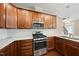 A kitchen with wood cabinets, stainless steel appliances, a gas cooktop, and granite countertops at 111 Wards Ridge Dr, Cary, NC 27513