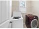 Functional laundry room with a modern washer and dryer and wire shelving at 111 Wards Ridge Dr, Cary, NC 27513
