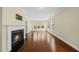 Bright living room featuring a fireplace, hardwood floors, and large windows with natural light at 111 Wards Ridge Dr, Cary, NC 27513