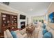 Inviting living room with fireplace, built-ins, plush seating, and large windows at 111 Wards Ridge Dr, Cary, NC 27513