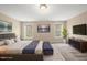 The main bedroom is decorated with stylish furniture, TV, windows, and artwork at 111 Wards Ridge Dr, Cary, NC 27513