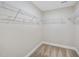 Walk-in closet with wire shelving and neutral carpeting offering ample storage space in a well-lit room at 111 Wards Ridge Dr, Cary, NC 27513