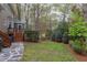 Backyard featuring healthy grass, trees, hedges, mulch, and a stone path at 1159 Belfair Way, Chapel Hill, NC 27517