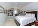 Bright bedroom features built-in bookshelves, a ceiling fan, and a comfortable-looking bed with white comforter at 1159 Belfair Way, Chapel Hill, NC 27517