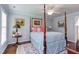 Cozy bedroom featuring a four-poster bed, ceiling fan, and neutral walls with colorful accents at 1159 Belfair Way, Chapel Hill, NC 27517