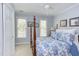 Bedroom with a four-poster bed, neutral carpeting, and two windows at 1159 Belfair Way, Chapel Hill, NC 27517