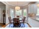 Cozy breakfast nook with bay windows, hardwood floors, and a stylish chandelier at 1159 Belfair Way, Chapel Hill, NC 27517
