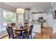 Bright dining area featuring hardwood floors, a wooden table, and natural light from the windows at 1159 Belfair Way, Chapel Hill, NC 27517